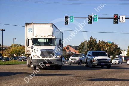 A delivery truck in traffic making a left turn at an intersection in Boise, Idaho.