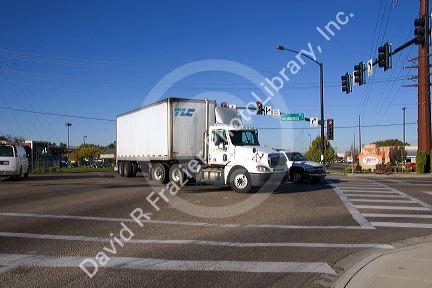 A delivery truck in traffic making a left turn at an intersection in Boise, Idaho.