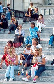 People on the steps at Trafalgar Square in London, England.