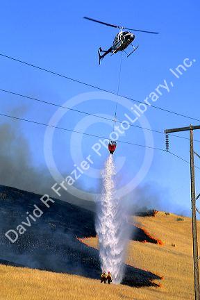A Jet Ranger helicopter dropping water on a wildfire in Idaho.