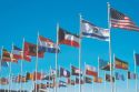 Flags of many nations flying on flag poles at church in Lansing, Michigan.