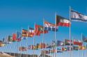 Flags of many nations flying on flag poles at church in Lansing, Michigan.