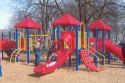 Children playing on plastic playground equiptment.