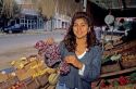 A fruit stand vendor holding grapes in Concon, Chile.