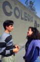 Mexican high school students talking outside school in Mexico City.
