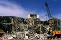 Building demolition using a wrecking ball.