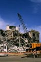 Building demolition using a wrecking ball.