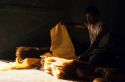 Processing raw latex in Malaysia.  Cured latex is inspected for foreign objects which are cut out.