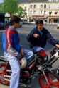 Teens ride motorbikes in France.