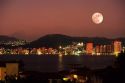 Full moon at night over Acapulco, Mexico.