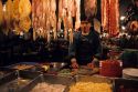 A man works at a night market selling meat and fish in Hong Kong.