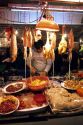 A man works at a night market selling meat and fish in Hong Kong.