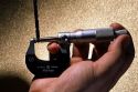 Micrometer measuring a drill bit.