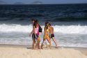 Visitors walk on the Copacabana Beach in Rio de Janeiro, Brazil.