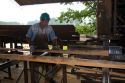 Sawyer cutting logs at a lumber mill in Argentina.
