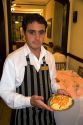 Waiter serving food at a restaurant in Neccochea, Argentina.