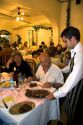 Waiter serving food at a restaurant in Argentina.