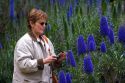 Woman photographing flowers in Monterey, California.