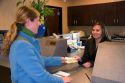 Customer depositing cash at a teller window.