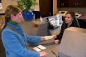 Customer depositing cash at a teller window.