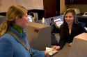 Customer depositing cash at a teller window.