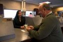 Customer depositing cash at a teller window.