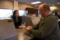 Customer depositing cash at a teller window.