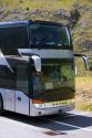 A European tour bus traveling in the Austrian Alps, Austria.
