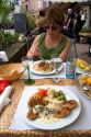 Woman dining at sidewalk restaurant in Ribeauville, France.