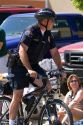 Police officer on a bicycle at a small town Fourth of July parade in Cascade, Idaho.