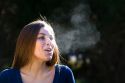 Young woman exhaling in the cold winter air. MR