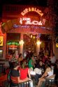 People gather and socialize in front of a bar in Buenos Aires, Argentina.