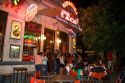 People gather and socialize in front of a bar in Buenos Aires, Argentina.