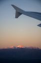 Aerial view of the Andes in Argentina at sunrise through the window of an airplane.