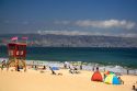 Beach scene in Renaca on the Pacific Ocean in Chile with Vina del Mar and Valparaiso in the background.
