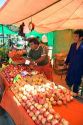 Vendor selling fruit at an outdoor produce market in Valparaiso, Chile.