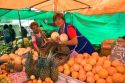 Woman selling produce at an outdoor market in Valparaiso, Chile.