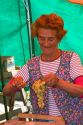 Woman selling produce at an outdoor market in Valparaiso, Chile.