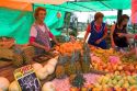 Woman selling produce at an outdoor market in Valparaiso, Chile.