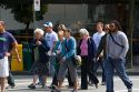 A diverse group of people crossing the street in Vancouver, British Columbia, Canada.