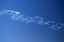 Small airplane sky writing over Boise, Idaho, USA.