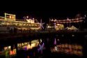 Floating restaurants on the Saigon River with lights at night in Ho Chi Minh City, Vietnam.