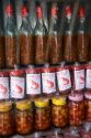 Vendor selling bottles of fish and shrimp sauces in the coastal town of Lang Co in Vietnam.