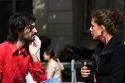 French man and woman have a conversation near the Sorbonne in Paris, France.