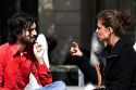 French man and woman have a conversation near the Sorbonne in Paris, France.