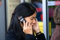 Asian female student talking on a cell phone in the Latin Quarter of Paris, France.