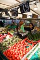 People shopping for produce at an outdoor Saturday market in Paris, France.