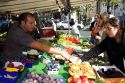 People shopping for produce at an outdoor Saturday market in Paris, France.