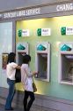 Customers using bank Automated Teller Machines in Paris, France.