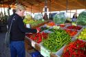 Woman shopping for a variety of peppers at an outdoor farmers' market in Fruitland, Idaho, USA. MR